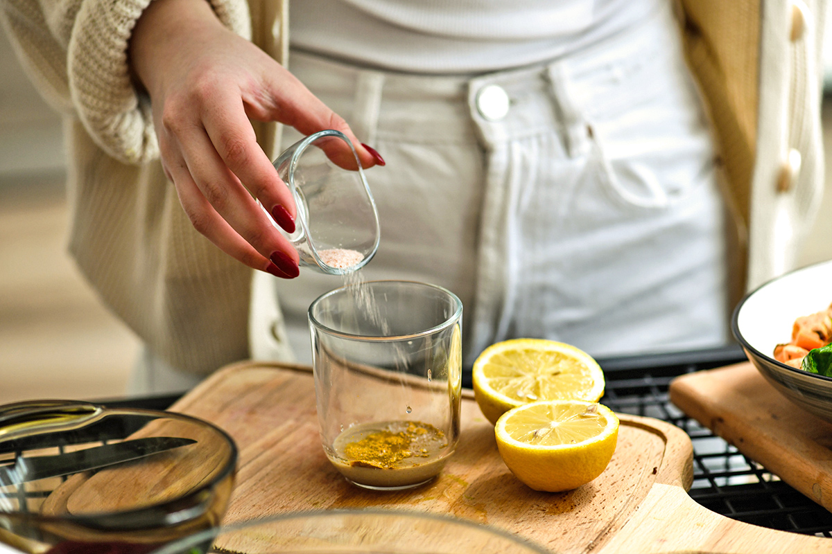 Close-up of adding salt to food for flavor