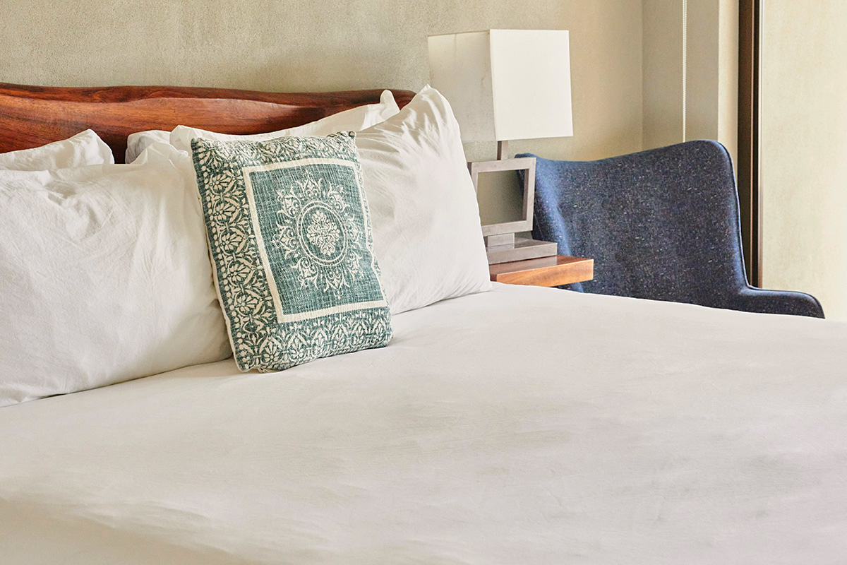 Neatly made bed in bedroom