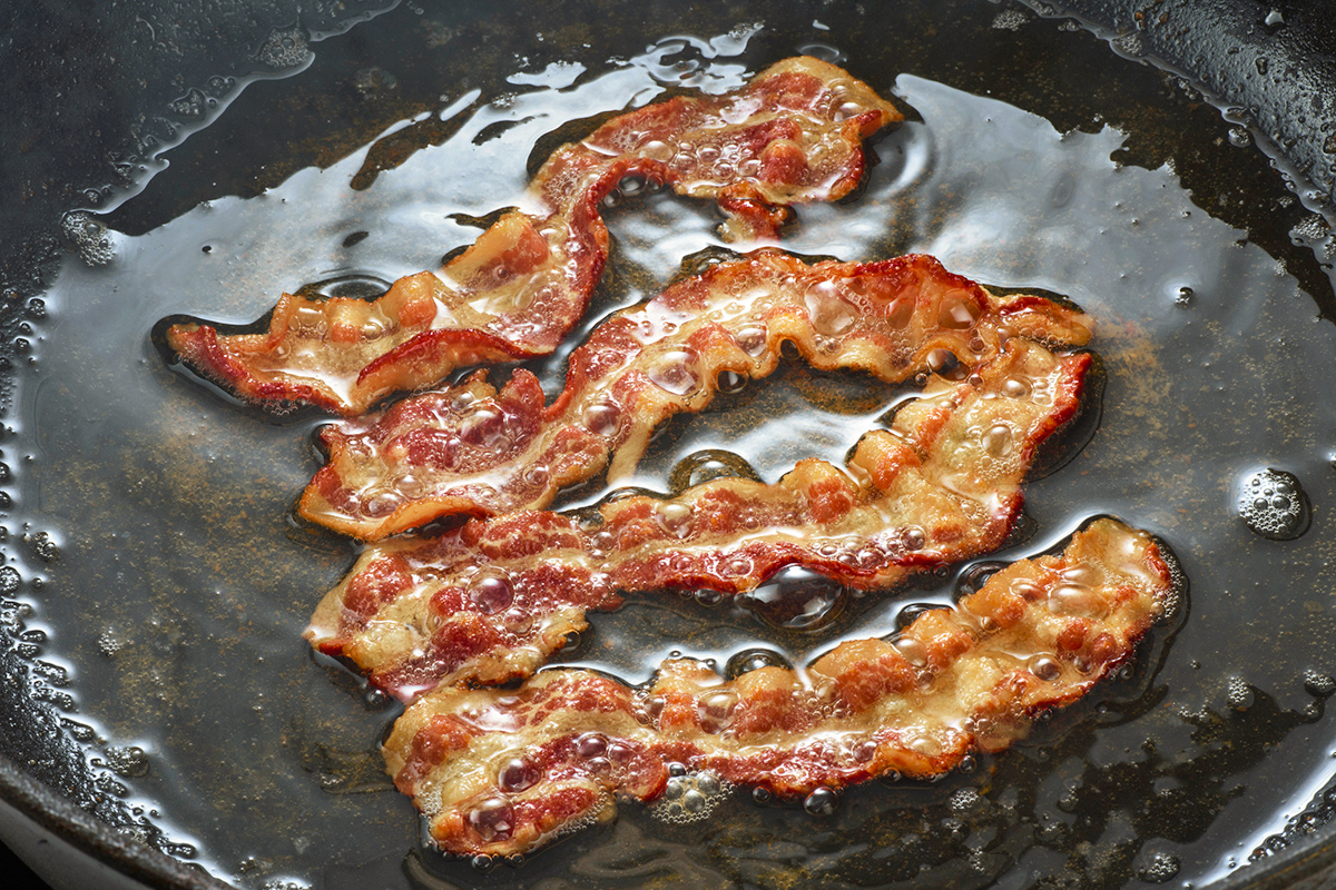 Bacon cooking on a skillet pan