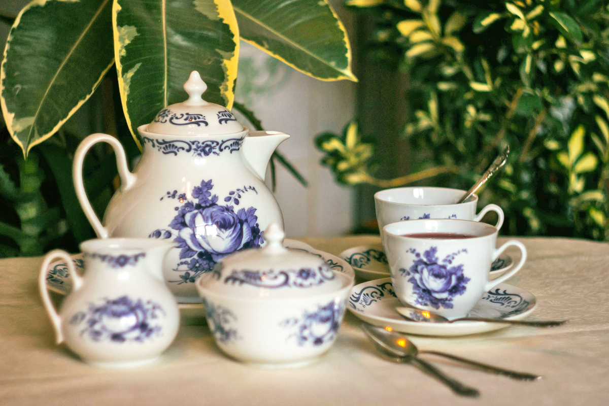 A vintage blue and white tea set with a floral pattern.